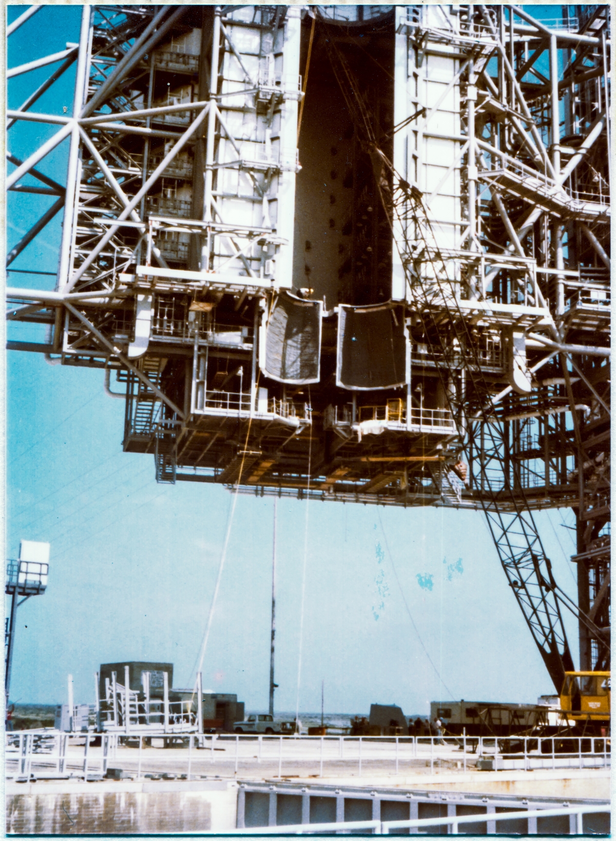 Image 069. The Rotating Service Structure at Space Shuttle Launch Complex 39-B, Kennedy Space Center, Florida, shortly after the new OMS Pod Heated Purge Covers had been installed, showing preparatory work for the installation of the ARCS Rooms underway, in addition to no end of other unseen preparations by Union Ironworkers from Local 808 for the huge grab bag of removals, modifications, and additions on both the RSS and the FSS which were encompassed by Engineering Drawing Package 79K24048. Photo by James MacLaren. Image 069. The Rotating Service Structure at Space Shuttle Launch Complex 39-B, Kennedy Space Center, Florida, shortly after the new OMS Pod Heated Purge Covers had been installed, showing preparatory work for the installation of the ARCS Rooms underway, in addition to no end of other unseen preparations by Union Ironworkers from Local 808 for the huge grab bag of removals, modifications, and additions on both the RSS and the FSS which were encompassed by Engineering Drawing Package 79K24048. Photo by James MacLaren.
